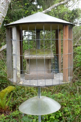 Wire house allows small birds to feed freely and securely
